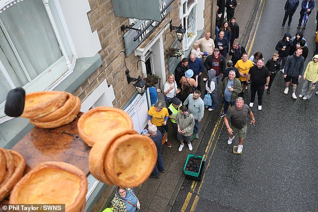 Spectators Cheer as Competitors Hurl Black Pudding Slices to Knock Yorkshire Puddings from 20-Foot Plinth in Ramsbottom